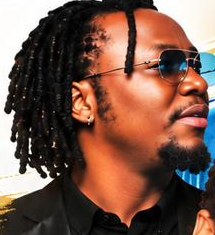 Band member with locs and glasses